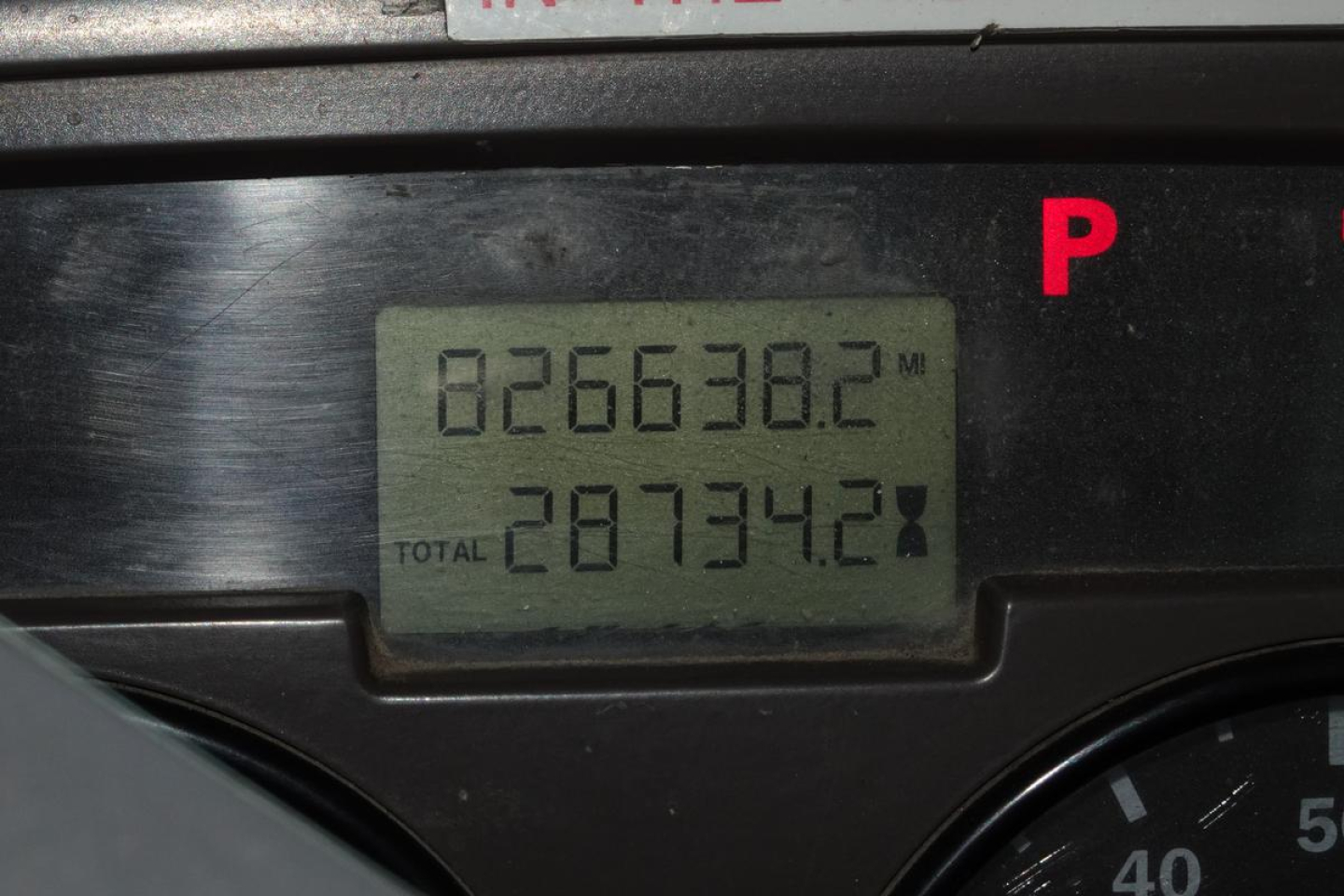 Truck dashboard display showing total mileage 28734.28 and trip 82663.82 in a Mack CV Granite CV713 cab.