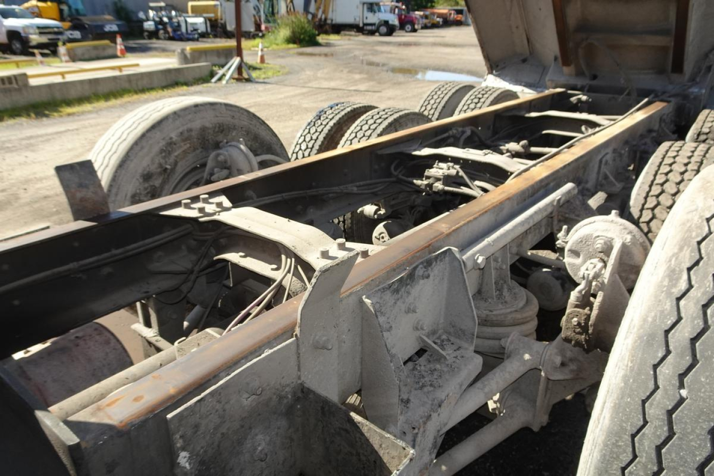 Mack CV (Granite) CV713 dump truck chassis frame and rear axles with dual rear wheels; metal frame, components, and suspension visible
