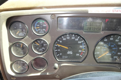 Dashboard of a 2005 Mack CV (Granite) dump truck showing multiple gauges including RPM, speedometer, coolant temp, and fuel/odometer readouts.