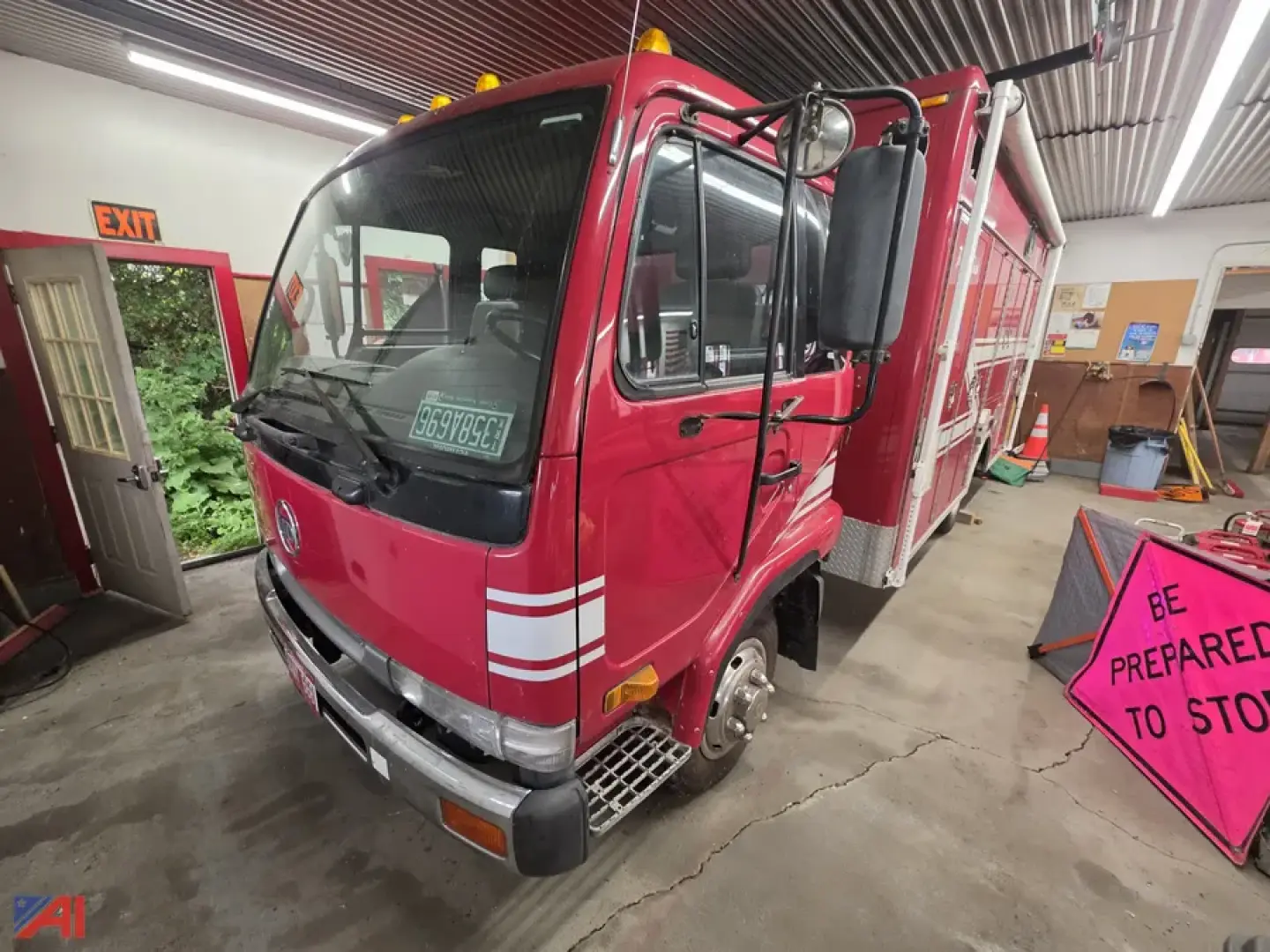 Front-left view of a red 1995 Nissan UD 1800 rescue truck with large cab, white stripe decals, and emergency equipment area visible in the back.