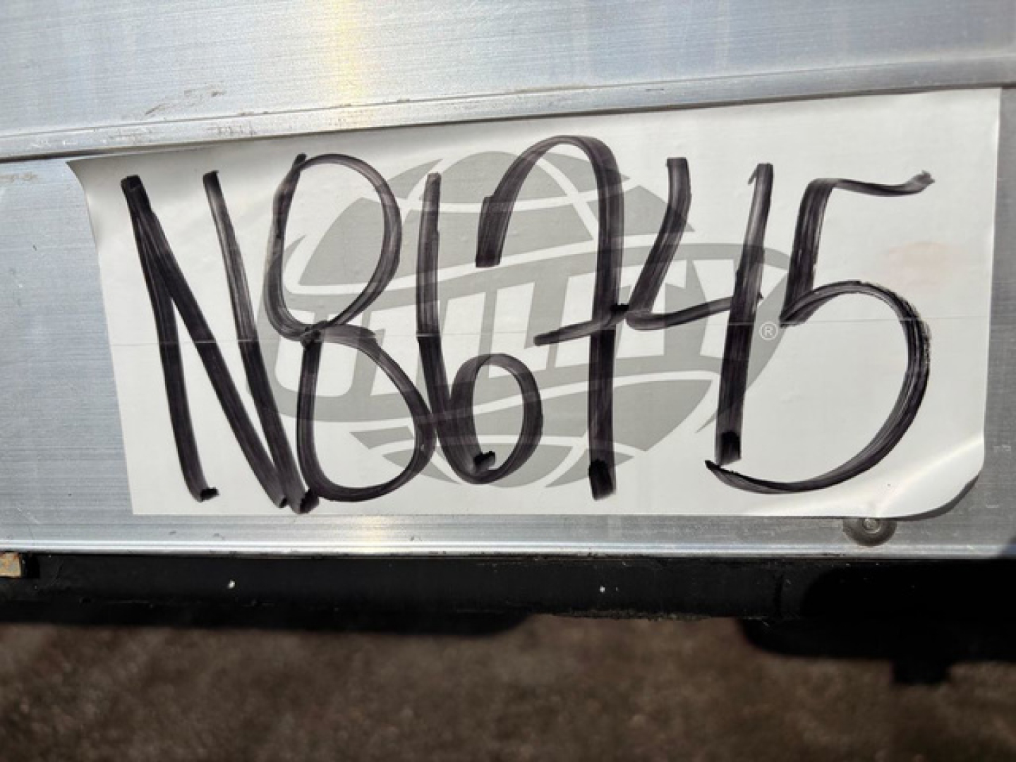 Vehicle exterior showing a large painted stock number N86745 on a trailer side panel.