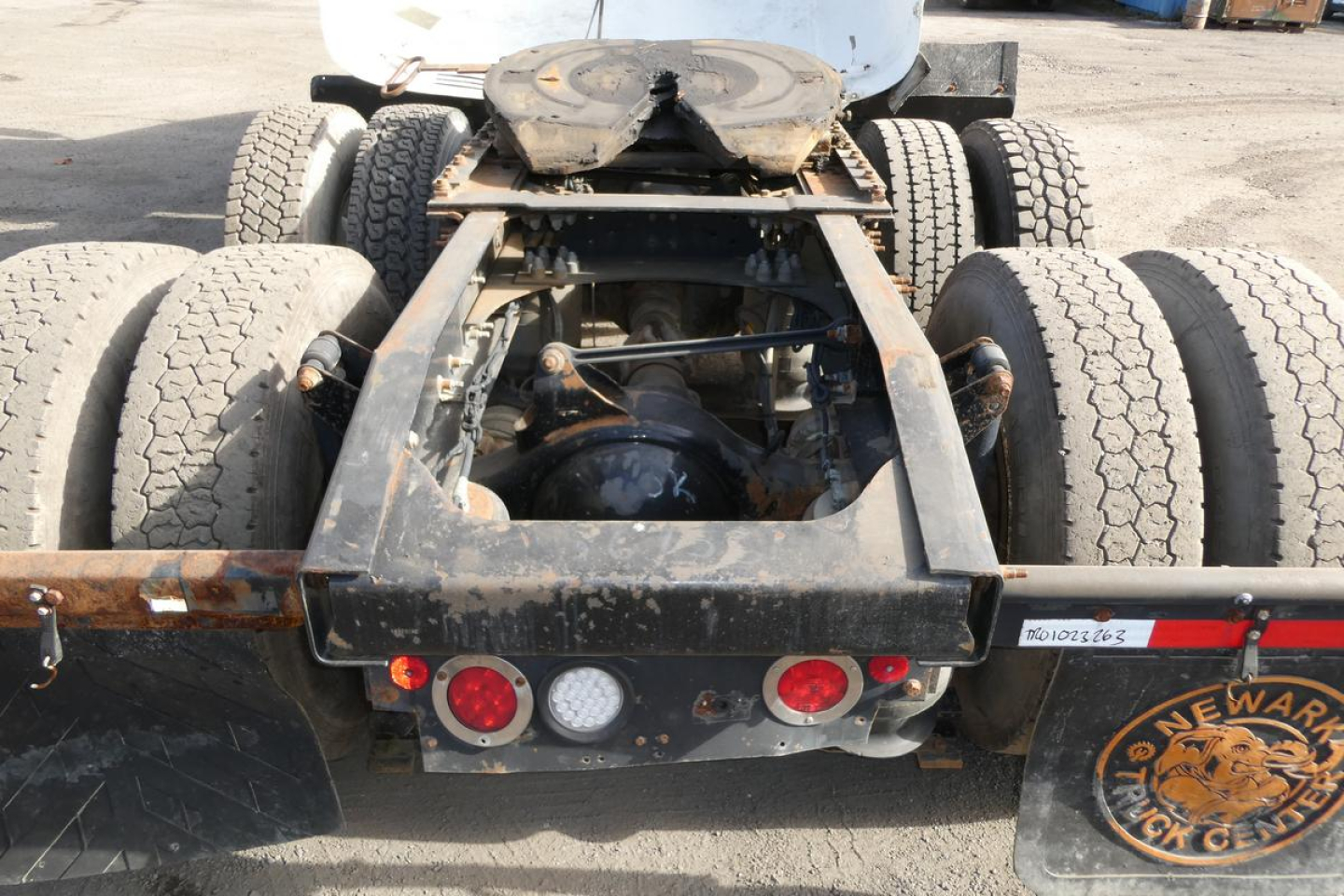 Rear view of a 2016 Mack CXU Pinnacle truck chassis showing dual rear axles, suspension, and frame with visible wheels and mud flaps.