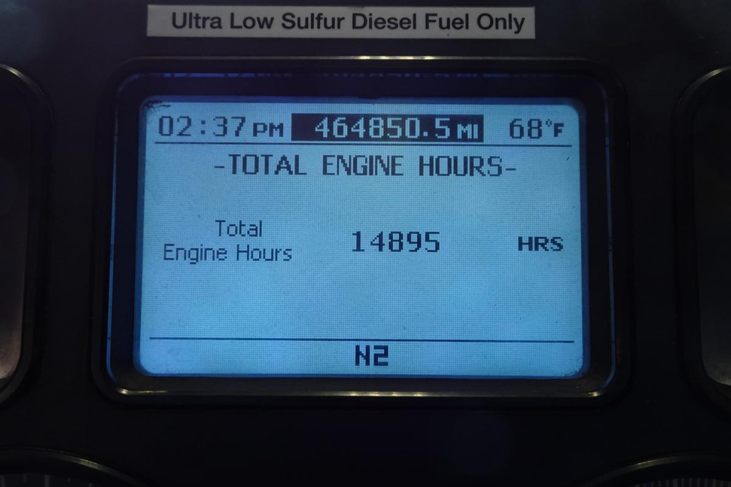 Dashboard display showing total engine hours: 14,895 hours; 68°F; mileage 464,850.5 miles; time 02:37 PM; label Ultra Low Sulfur Diesel Fuel Only; N2.