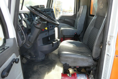 Truck cab interior showing steering wheel, driver's seat, and dashboard of a 2016 Mack CXU Pinnacle truck.