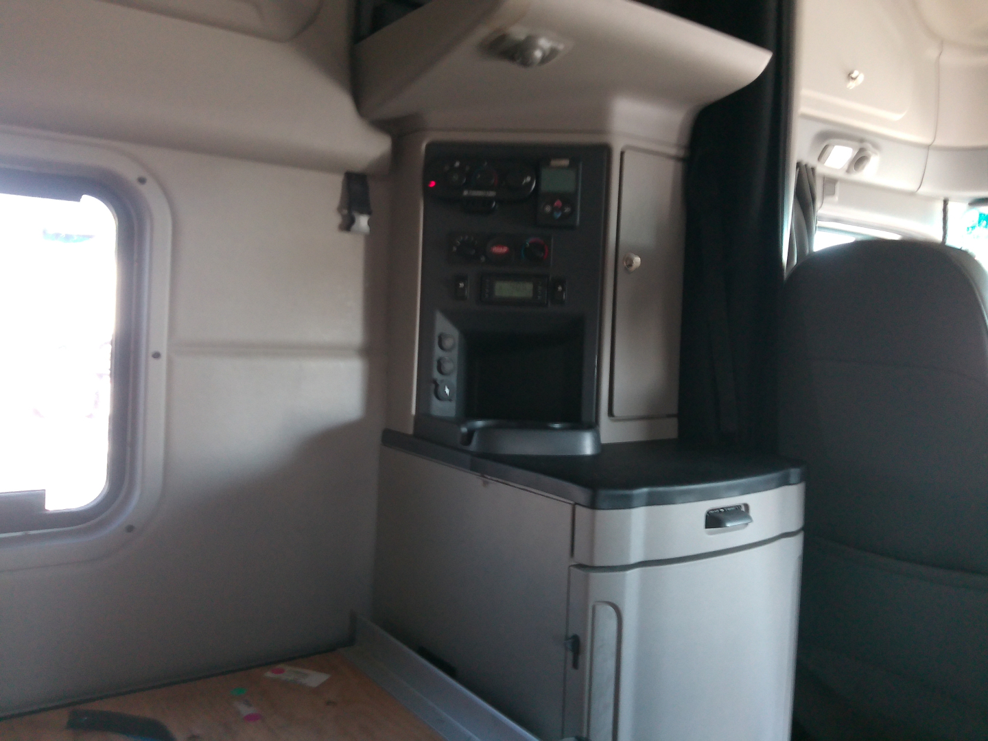 Peterbilt 579 cab interior showing control panels and storage compartment