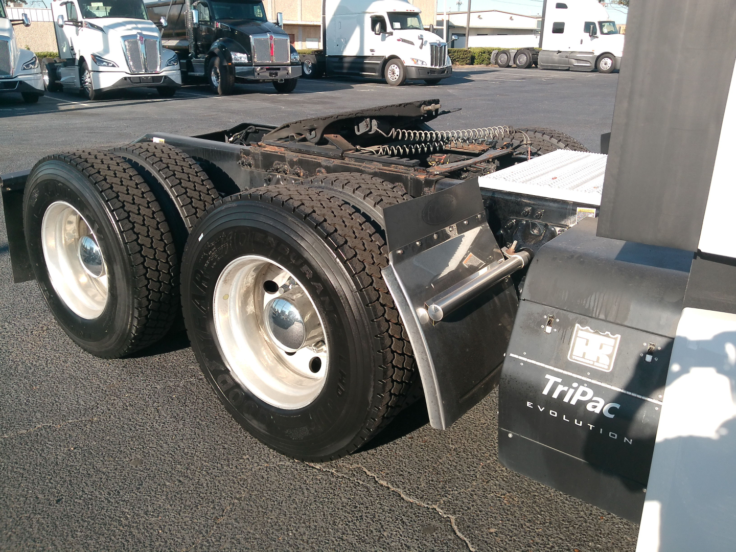 Peterbilt 579 tractor rear axle and dual wheels with fuel/air compartments and TriPac Evolution badge visible.