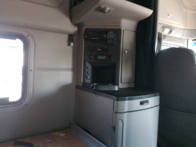 Peterbilt 579 cab interior showing control panels and storage compartment