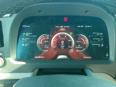 Peterbilt 579 digital instrument cluster display showing various readouts and gauges in red/black theme; left displays oil temp, torque, boost; center shows speedometer 0 MPH and RPM 650; right shows brake/app, fuel, coolant; top shows time