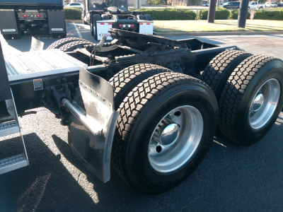 Peterbilt 579 chassis rear showing dual tandem axles and heavy-duty tires with chrome wheels.