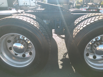 Peterbilt 579 truck rear dual tires and chassis view showing wheel hubs and suspension mounting.