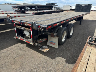 Flatbed trailer showing 38' steel deck with triple axle and forklift kit donor. Rear tail lights and mud flaps, Clark branding, and wood deck surface.