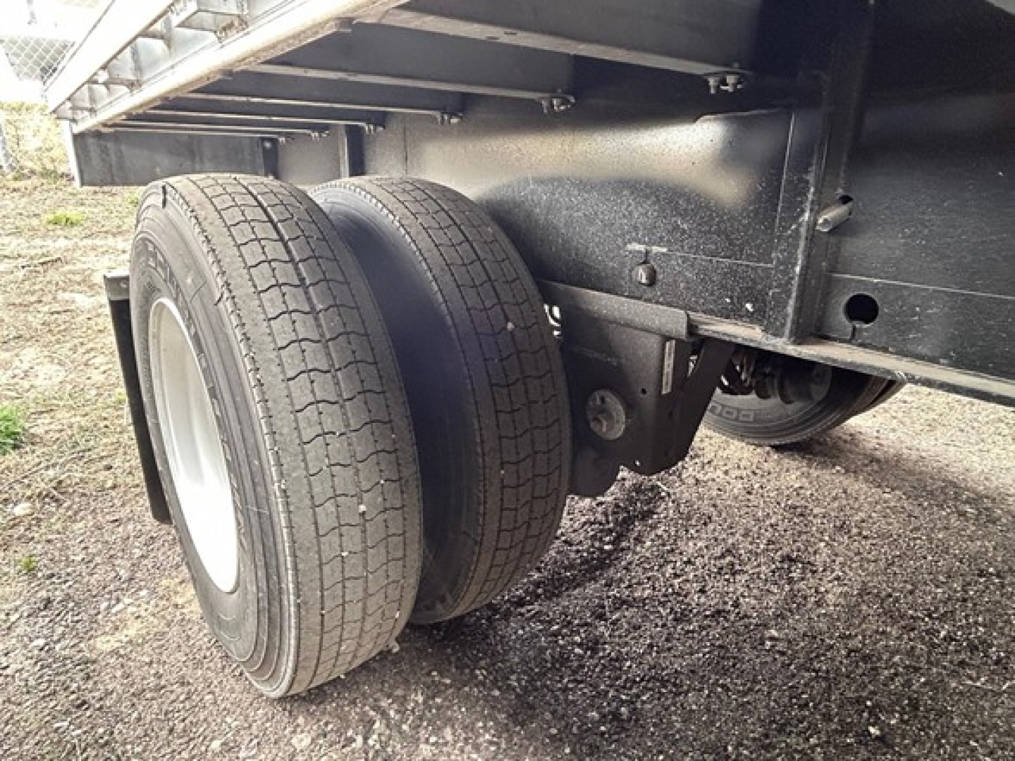 Manac Legend trailer undercarriage showing dual rear tires and frame components