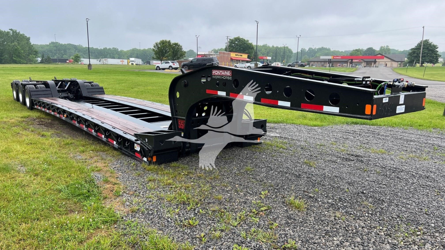 Fontaine 55 Lowboy trailer in new condition, flatbed with multiple axles and black finish, side ramps and deck details visible.