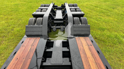  Fontaine 55 Lcc lowboy trailer frame with dual axle and wood deck sections, perspective view showing wheel groups and steel rails.
