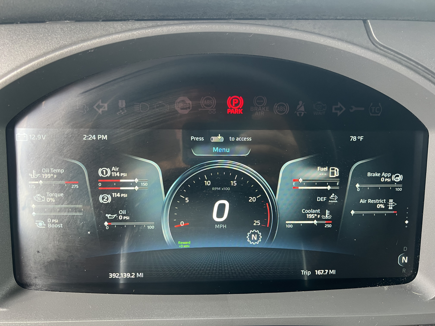 Kenworth T680 digital instrument cluster display showing speedometer at 0 mph, engine gauges, fuel, DEF, coolant, and tachometer readouts; multiple warning icons visible.