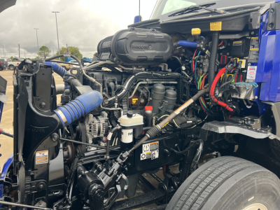 Kenworth T680 engine bay showing diesel fuel system and assorted hoses and wiring harnesses.