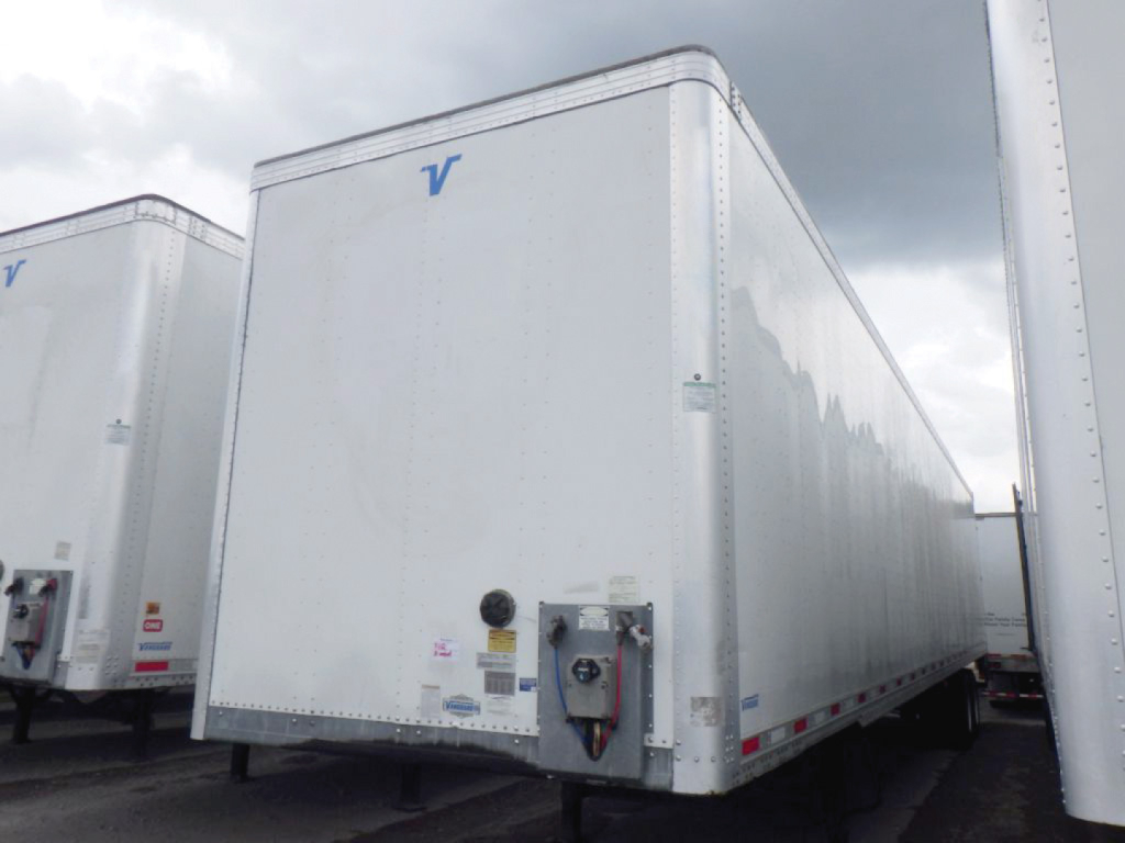 Vanguard aluminum dry van trailer showing front corner with DOMed hitch and blue Vanguard logo on white exterior
