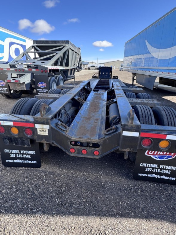Trailer chassis view showing dual fifth wheel undercarriage and multiple axles on a Fontaine lowboy trailer, steel frame with rust-like weathering and wheels.