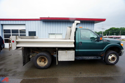 Ford F-350 dump truck side view showing dump bed and hydraulic system with green cab and silver dumping box.