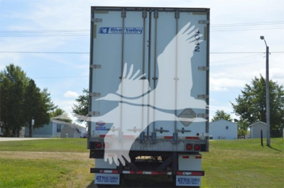 Rear view of a 2014 Utility 4000D-X trailer with River Valley logo on doors, taillights, and bumper reflectors visible.