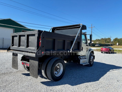 2009 Freightliner M2 106 dump truck rear and side view showing dump bed, taillights, and wheel, with VIN and stock info in listing context.