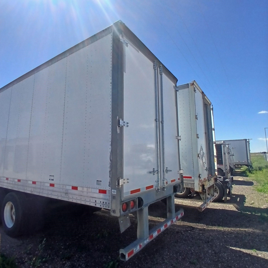 Hyundai air ride dry van trailer showing rear and side doors with reflective tape and bumper.