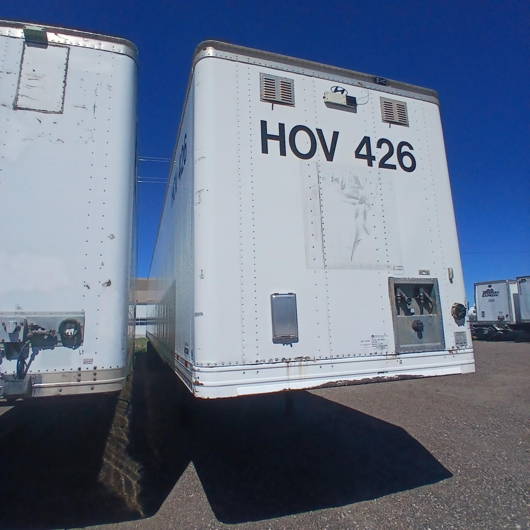 Hyundai air ride dry van trailer with HOV 426 marking on back, visible vents and access doors, parked among other trailers.