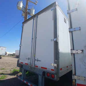 Rear view of a white Hyundai air ride dry van trailer with double rear doors and red reflective tape.