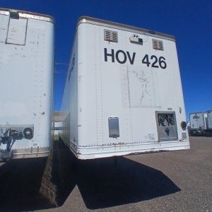 Hyundai air ride dry van trailer with HOV 426 marking on back, visible vents and access doors, parked among other trailers.