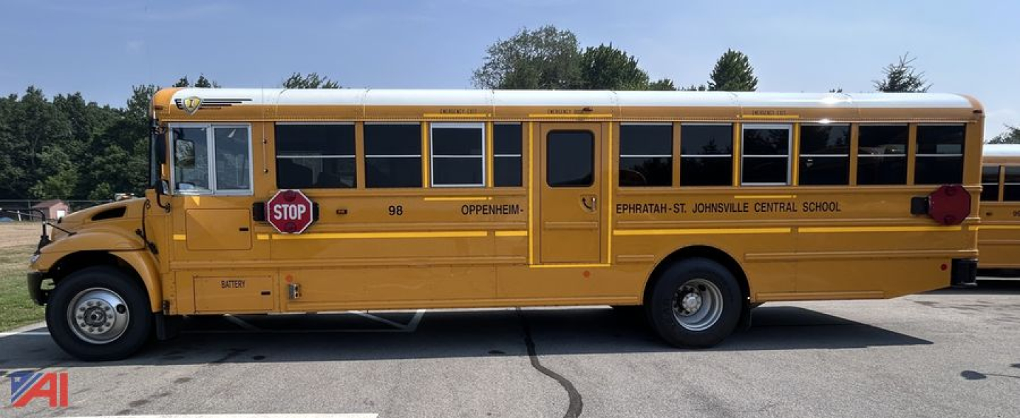 School bus side view showing yellow IC Corporation CE Series with stop sign extended and black lettering along the side.