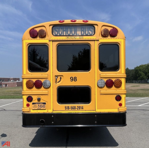Rear view of a yellow IC Corporation CE Series school bus showing school bus sign, tail lights, bumper, and bus number 98.
