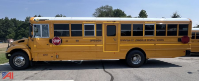 School bus side view showing yellow IC Corporation CE Series with stop sign extended and black lettering along the side.