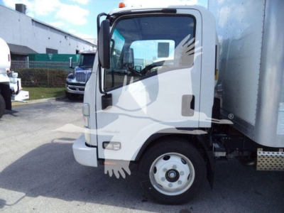 Isuzu NPR HD truck cab and box trailer front-left view showing side mirror, door handle, and wheel, box body with aluminum siding.