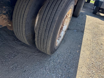 Rear dual tire assembly of a 2017 Fontaine 53' Cal Legal Combo Drop Deck trailer showing worn wheel rims and dual tires.
