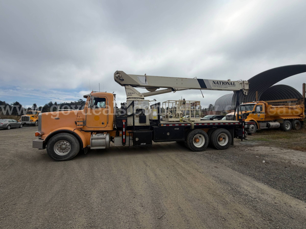 1999 Peterbilt 357 medium-duty truck with a crane, orange cab, mounted boom, and National crane branding. Side view shows VIN banner and stock number on listing.
