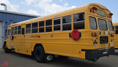 Yellow 2017 Blue Bird Vision school bus side/rear view showing center school bus logo, bus number 441, and 'CENTRAL SCHOOL' text along the side; rear lights and doors visible.