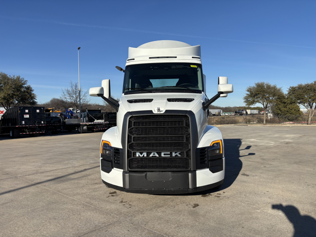 Front view of a white 2027 Mack PR64T conventional daycab truck showing large black grille, Mack emblem, headlights, and side mirrors.