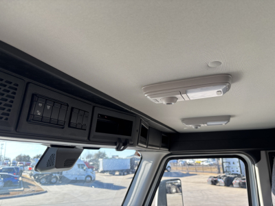 Cab interior showing overhead panel with switches and My Mack PR64T truck interior, view toward windshield.