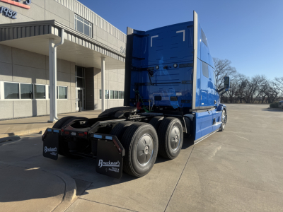 Blue 2026 Mack PR64T76H tractor truck rear three-quarter view showing sleeper cab and tandem axles.