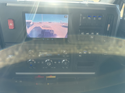 Mack PR64T76H truck cab dashboard with rearview monitor showing exterior view and control cluster