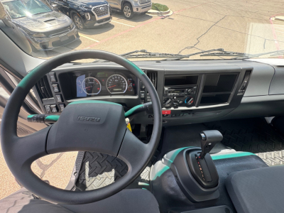 Isuzu FTR interior dashboard and steering wheel view showing gear shifter and instrument cluster.