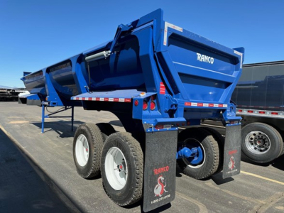 Ranco ED26-34 dump trailer in view showing blue body, dual rear axles, and Ranco branding.