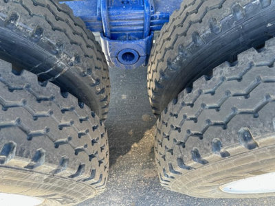 Ranco Ed26-34 dump trailer wheel set showing dual tires and axles with blue painted frame.