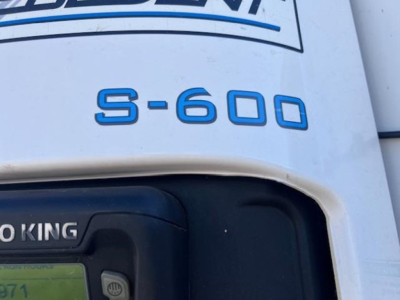 Trailer rear showing S-600 decal on white body and part of Thermo King logo on reefer unit.