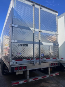 Trailer rear view of a 2022 Utility 3000R refrigerated trailer with diamond plate aluminum doors, CS528 decal, and rear bumper lights.