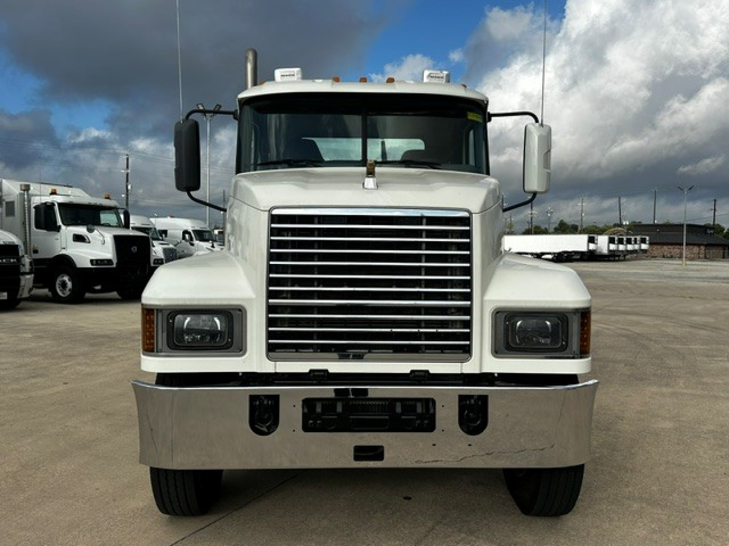 Front view of a white 2019 Mack PI64T conventional daycab truck showing large chrome grille, rectangular headlights, and heavy-duty bumper.