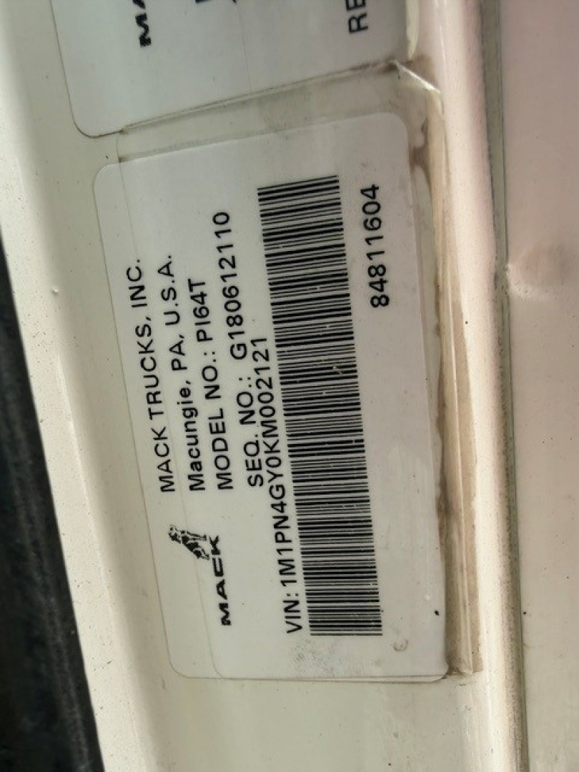Mack Trucks label on door jamb showing Make: Mack Trucks Inc., Model No: G10821, VIN: MPNG0... not fully legible, barcode sticker with 2019 Mack PI64T information.