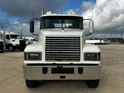 Front view of a white 2019 Mack PI64T conventional daycab truck showing large chrome grille, rectangular headlights, and heavy-duty bumper.