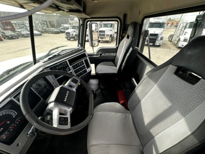 Interior of a 2019 Mack PI64T truck cab showing steering wheel, dashboard, and front seats. Visible text includes 'MACK' on the steering column badge and instrument cluster details.