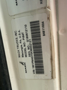 Mack Trucks label on door jamb showing Make: Mack Trucks Inc., Model No: G10821, VIN: MPNG0... not fully legible, barcode sticker with 2019 Mack PI64T information.